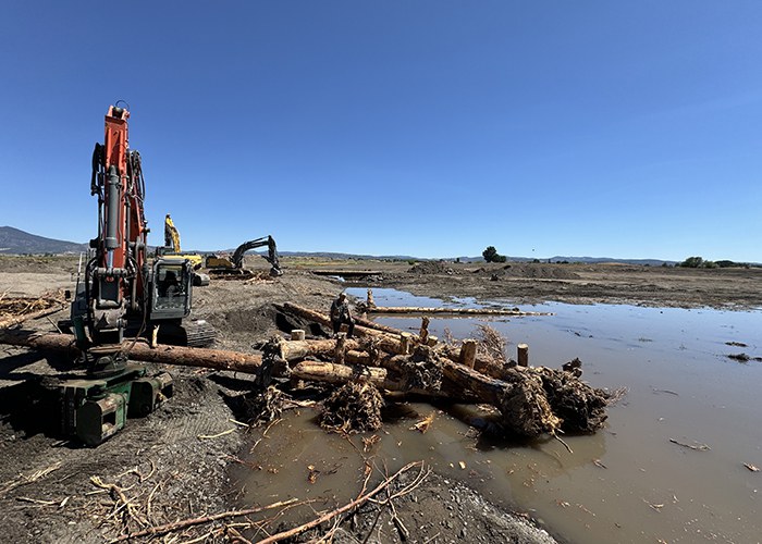 Crews work on constructing a habitat log jam in the new Crooked River alignment. Photo: Land Trust.